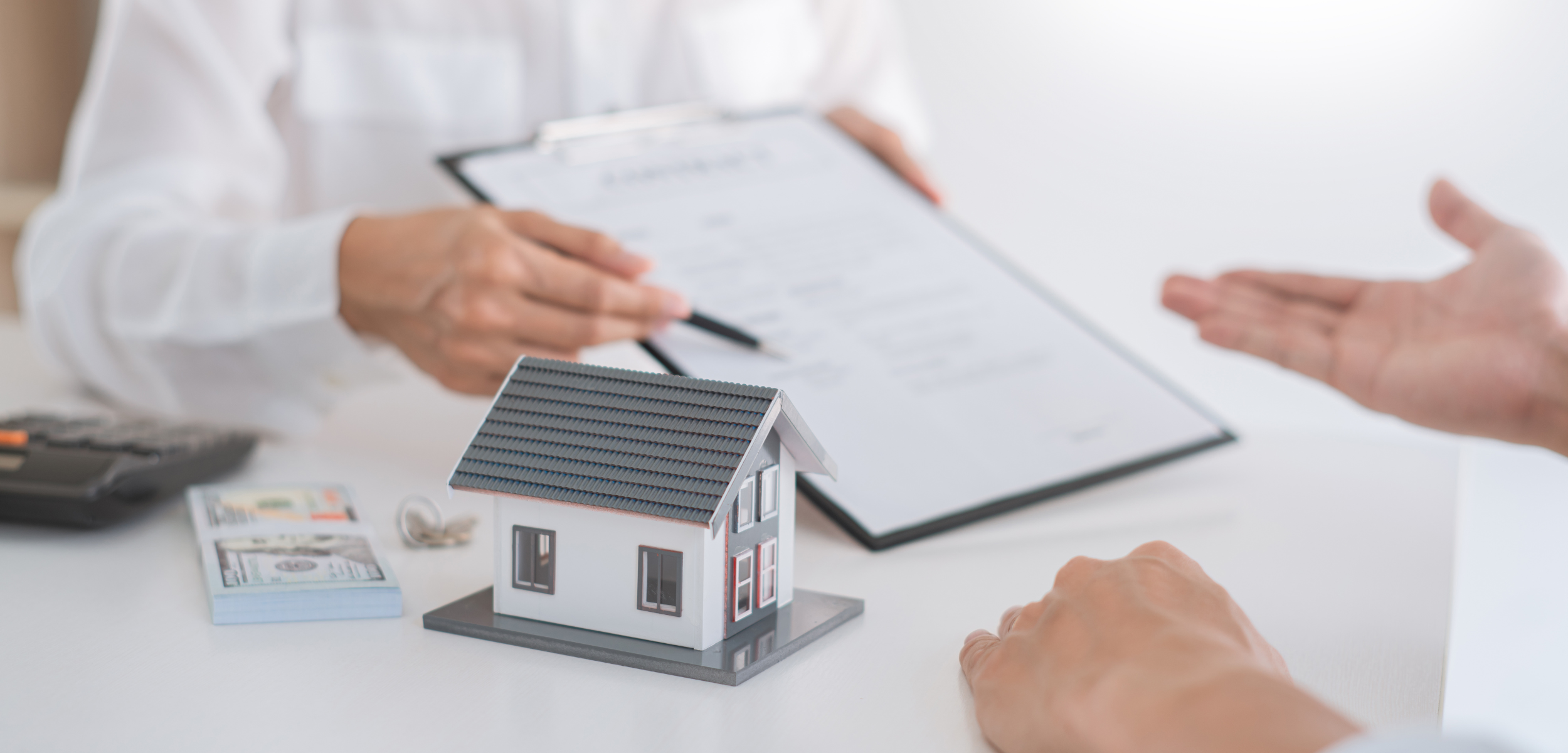 picture of meeting with a house explaining contract on a clipboard